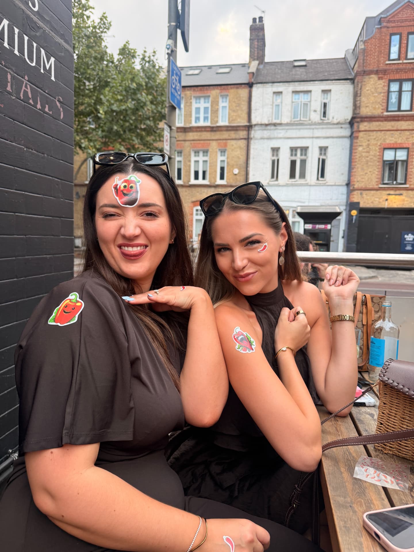 Guests wearing chilli stickers outside a bar