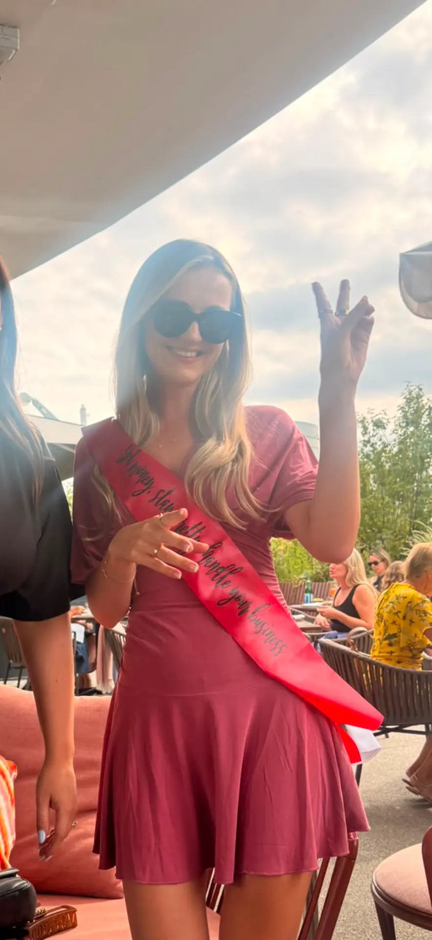 Birthday girl in a red sash reading go ahead and handle your business