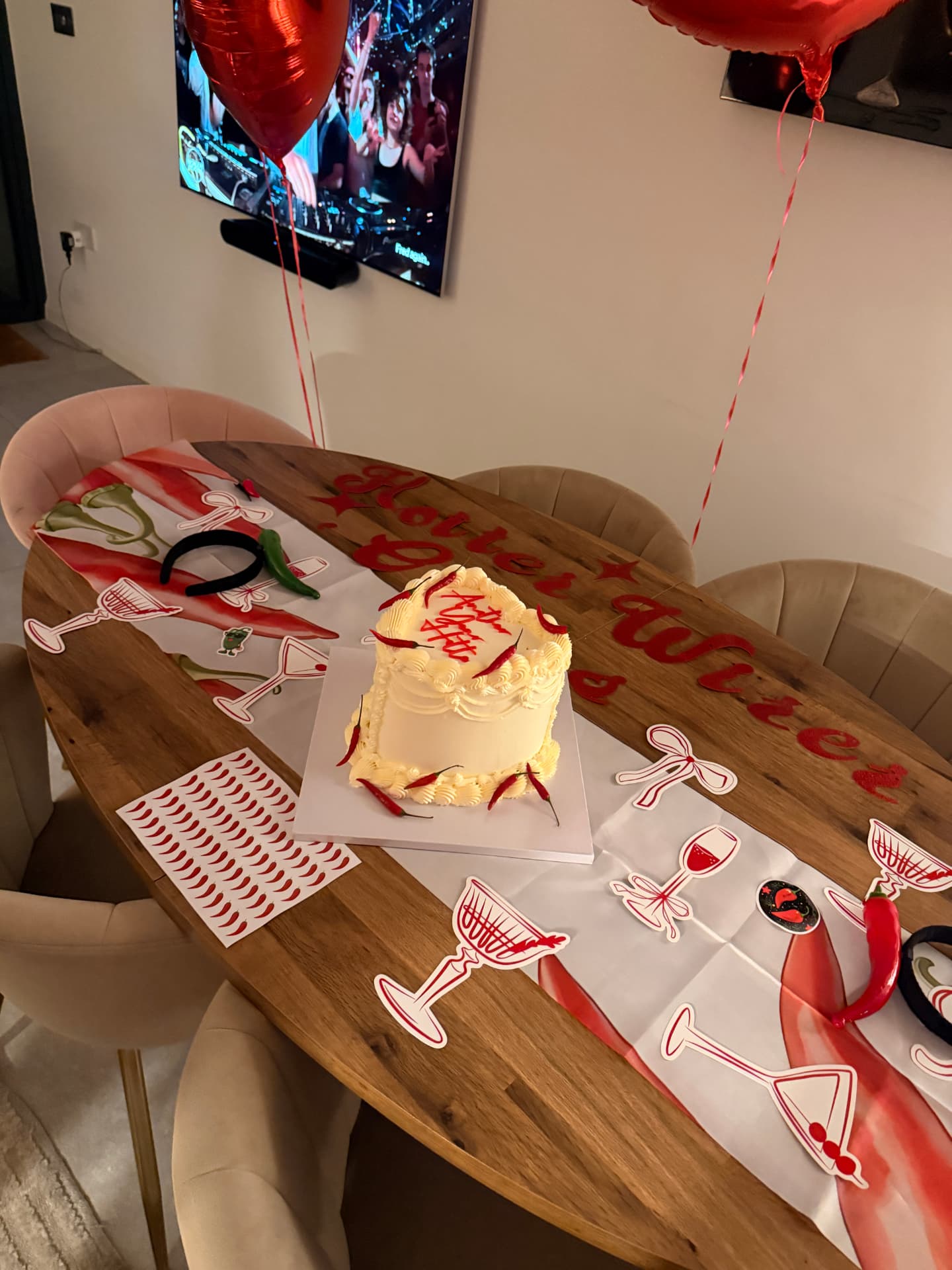 Chilli cake on a table with red heart balloons and matching place cards